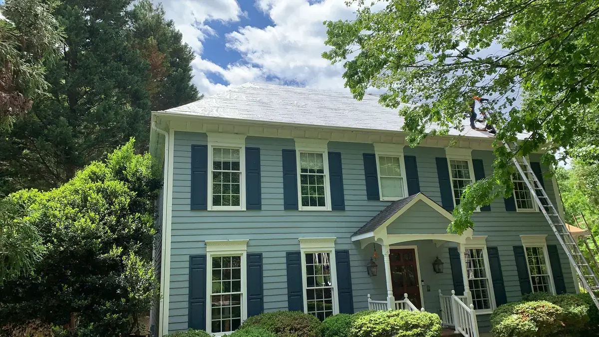 Blue clapboard colonial with a brand new light gray shingle roof