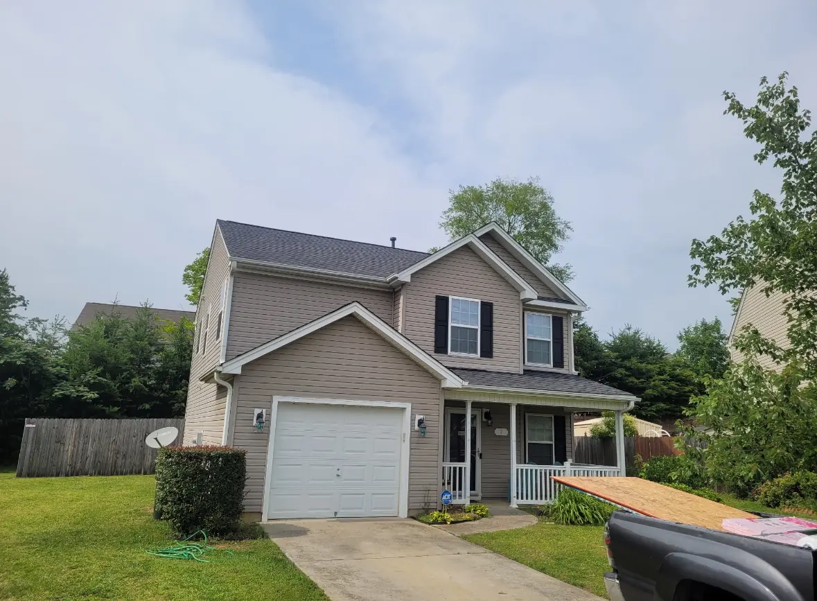 Two story house with its new shingle roof complete